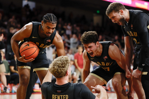 Purdue guard Jack Benter, center bottom, is congratulated by guards C.J. Cox, left, Omer Mayer (17) and Braden Smith, right, after blocking a shot by Southern California guard Jordan Marsh during the second half of an NCAA college basketball game Saturday, Jan. 17, 2026, in Los Angeles. (AP Photo/Caroline Brehman)