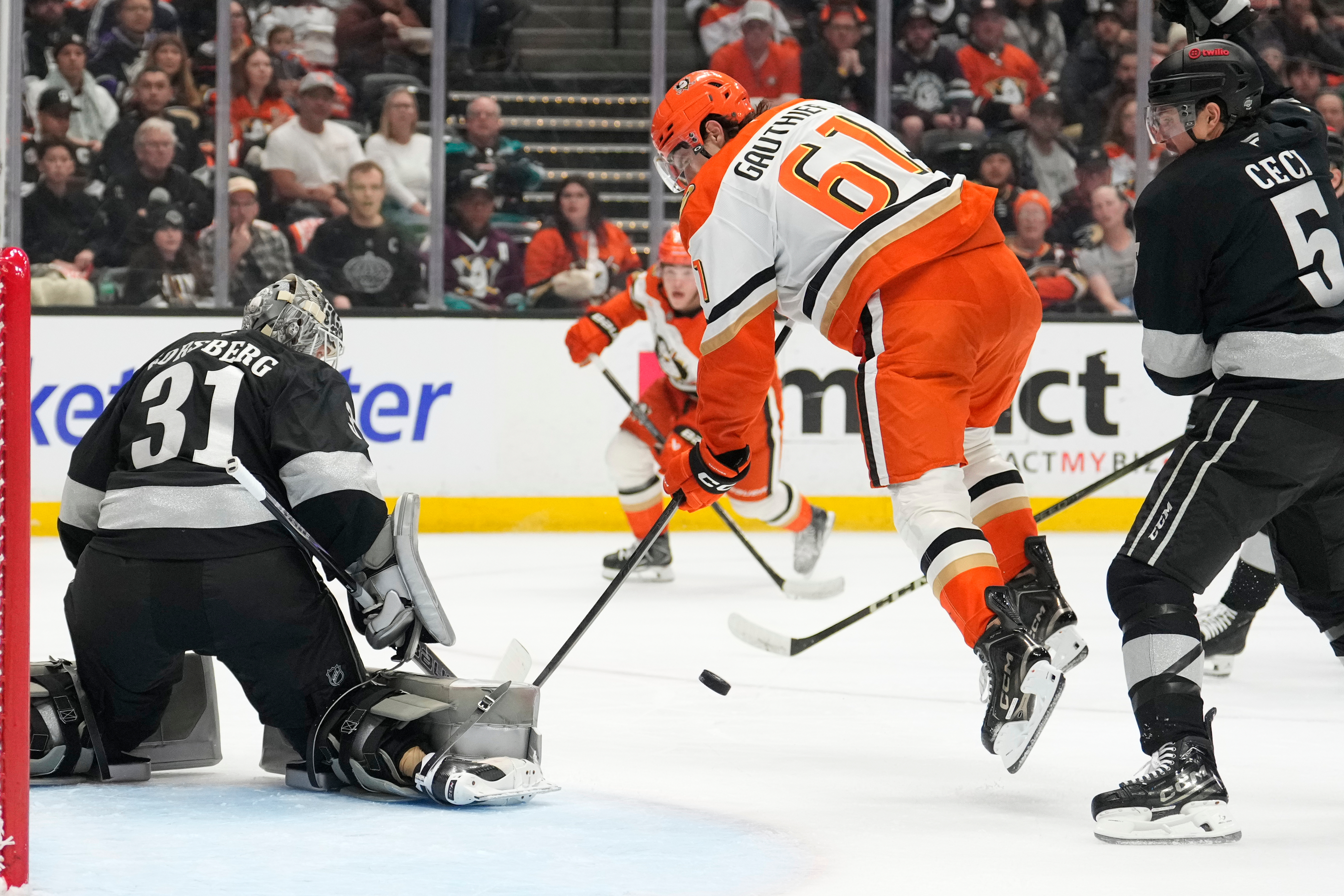 Kings goaltender Anton Forsberg, left, stops a shot as Ducks...