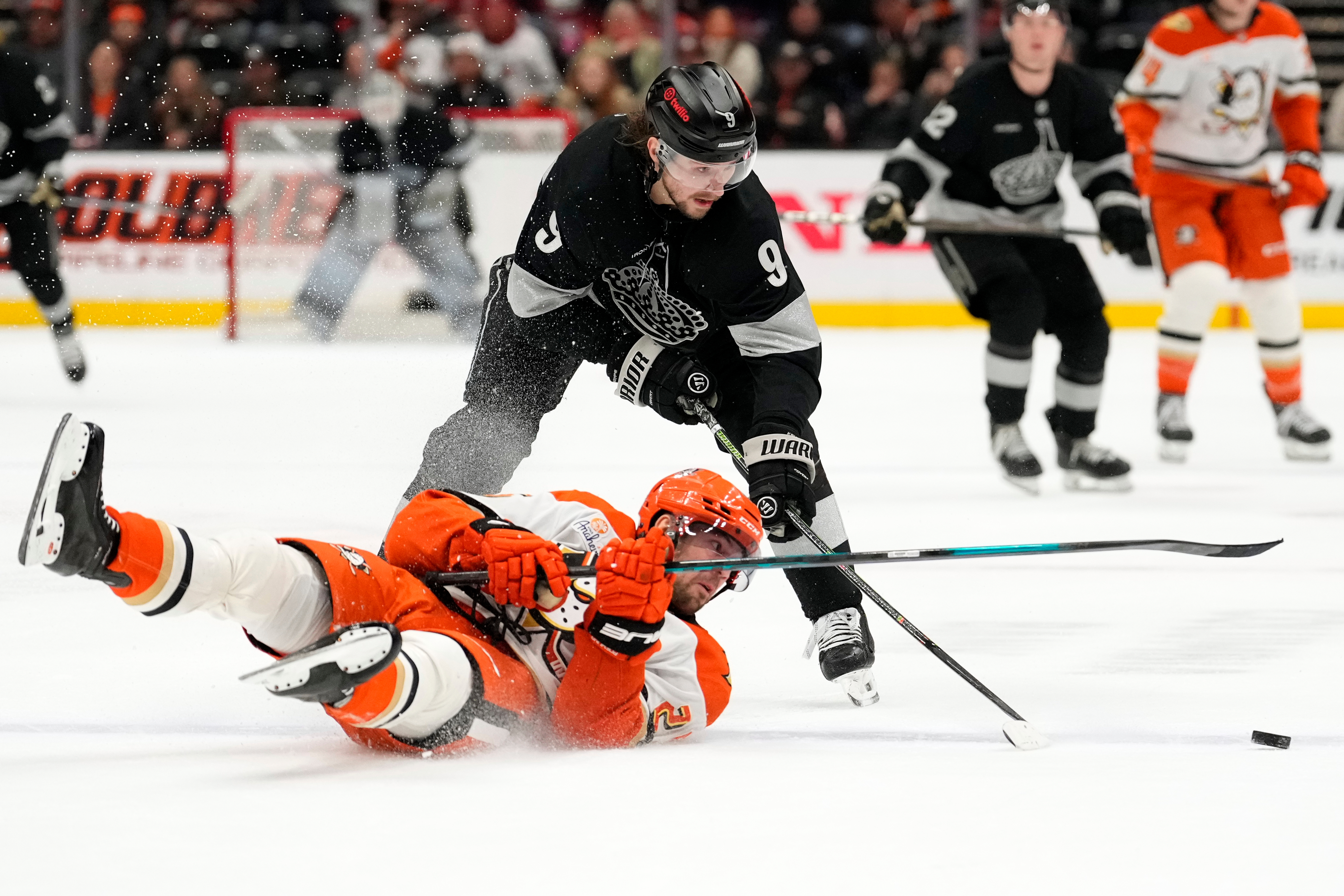 Ducks center Ryan Poehling, left, falls as Kings right wing...