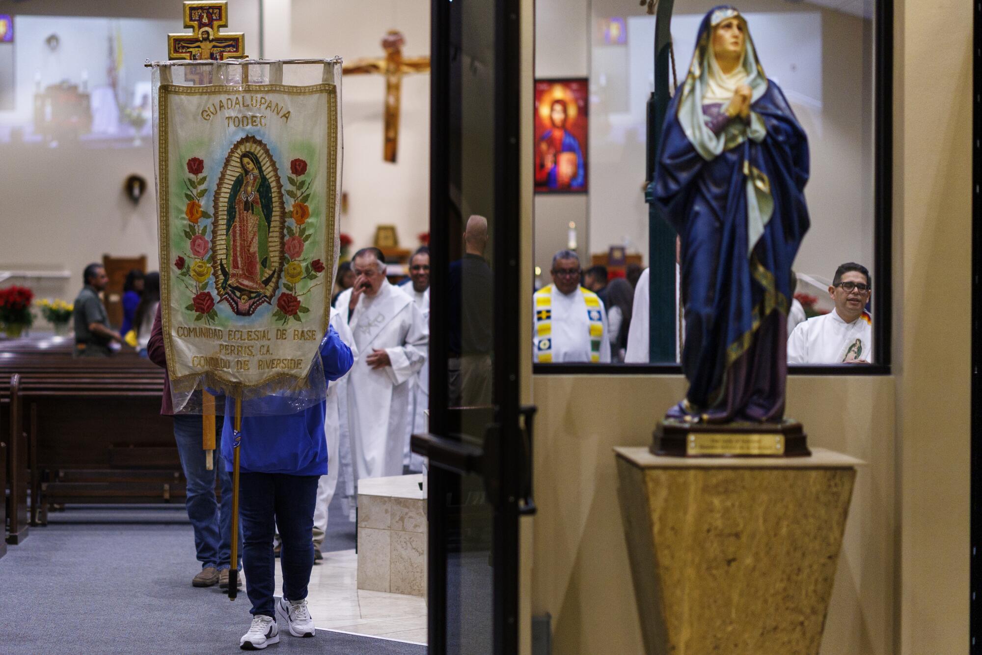 Parish staff and members of Todec Legal Center lead a procession after the memorial service.
