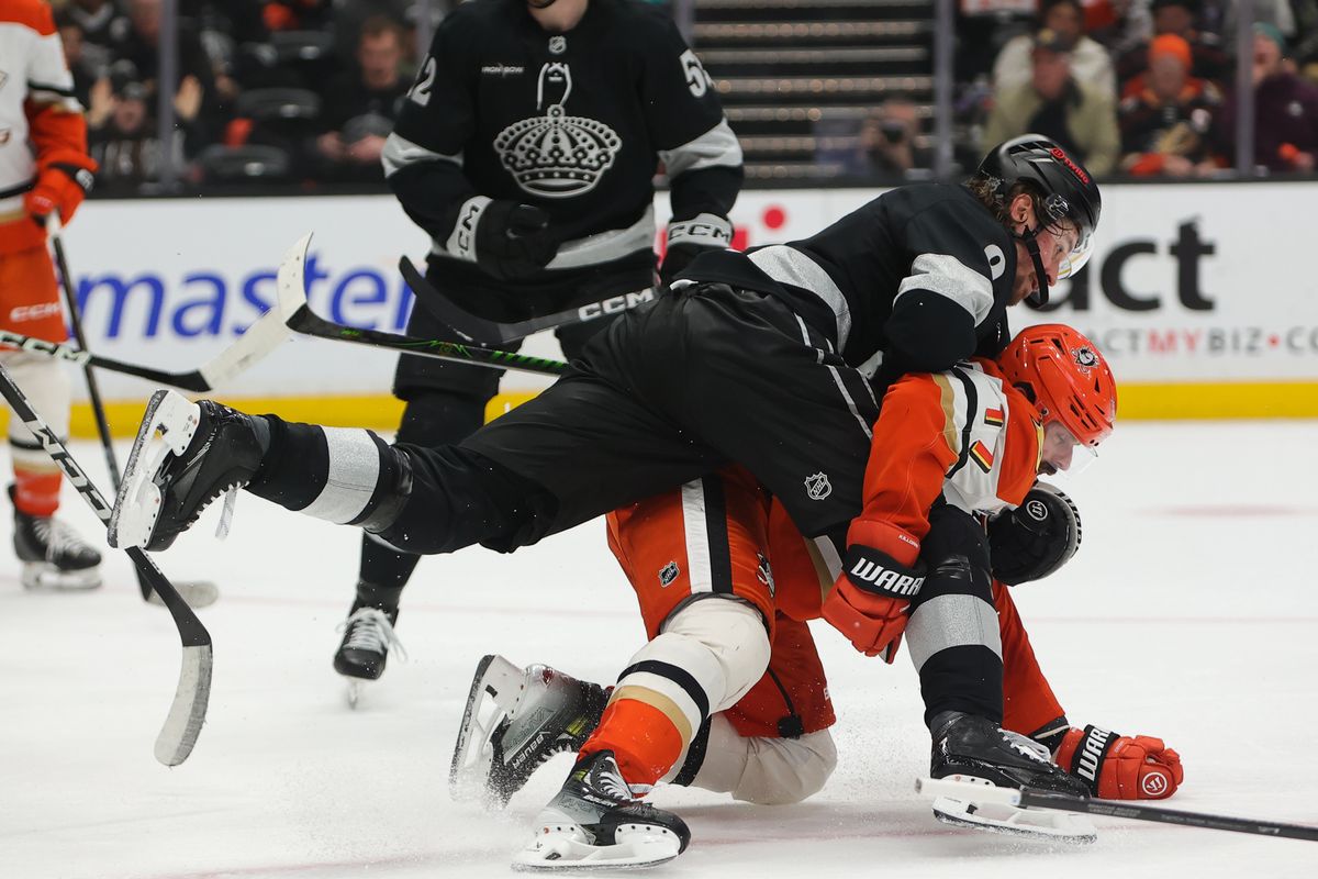 Los Angeles Kings right wing Adrian Kempe (9) tackles Anaheim Ducks left wing Alex Killorn (17) to the ice during an NHL game on January 17, 2026 in Anaheim, CA.