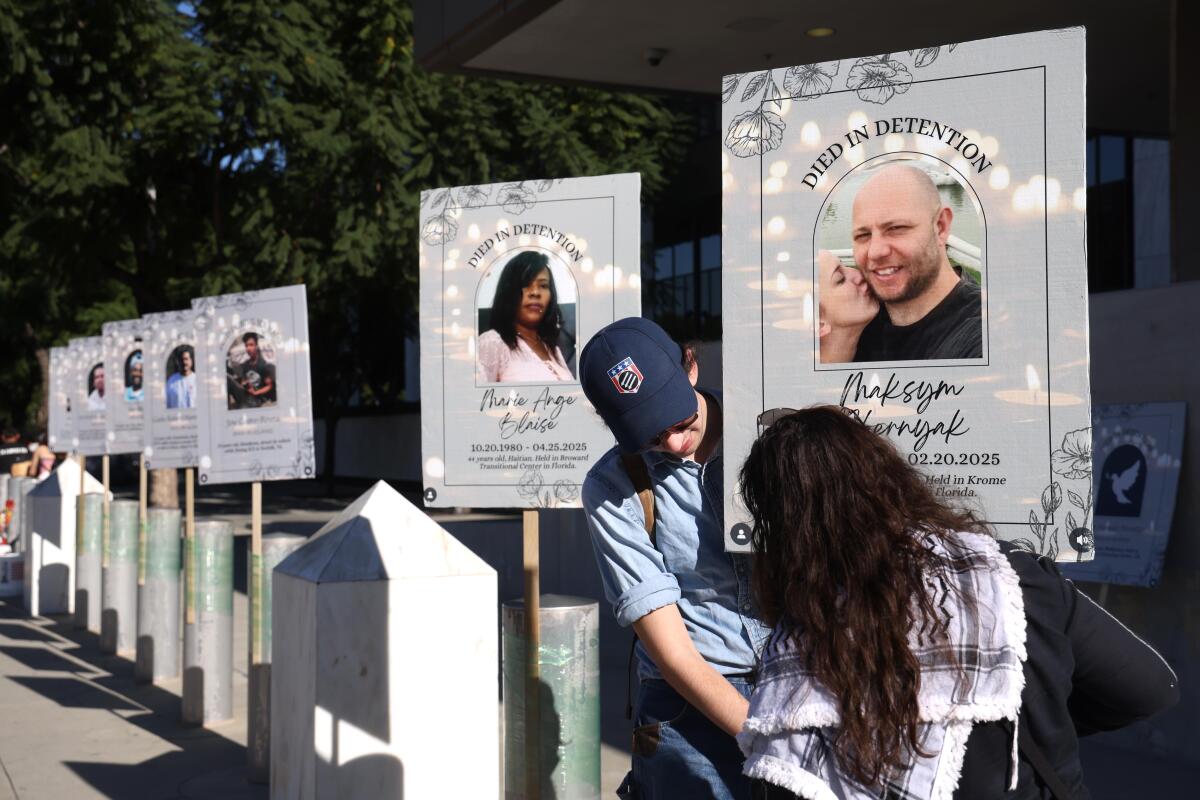 A pair of protesters set up signs memorializing individuals