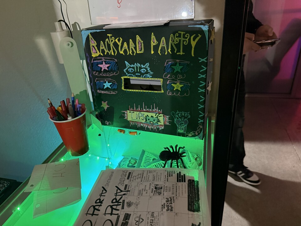 A black tip box has the words Backyard Party written in yellow paint marker. 