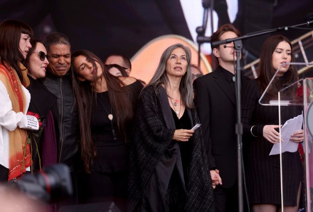 Bob Weir's wife Natascha Münter, center, with daughter Chloe, left, bassist Oteil Burbridge, and daughter Monet, far right, along with others, watches a hawk fly as Dead & Company guitarist John Mayer plays the Grateful Dead song "Ripple" during her dad's memorial at Civic Center Plaza in San Francisco, Calif., on Saturday, Jan. 17, 2026. Thousands of people gathered to say goodbye to the Grateful Dead's co-founder and guitarist, who passed away on Jan. 10. (Jane Tyska/Bay Area News Group)