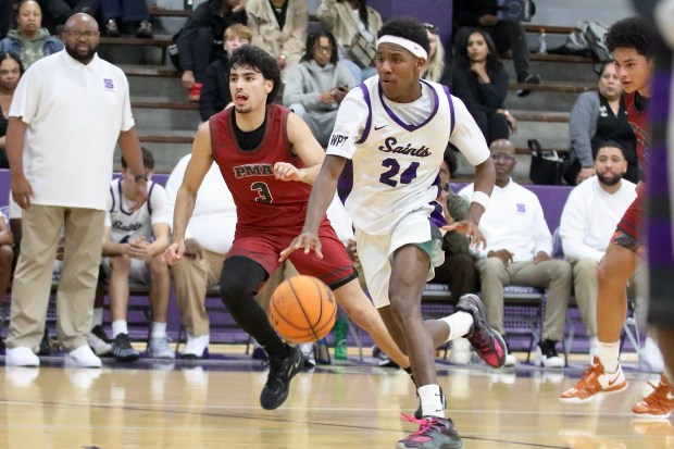 St. Anthony's Jamil House drives past St. Pius X-St. Matthias' Dominic Gallardo in Del Rey League action at St. Anthony High School in Long Beach on Monday, Jan. 12, 2026. (Photo by Howard Freshman, Contributing Photographer)