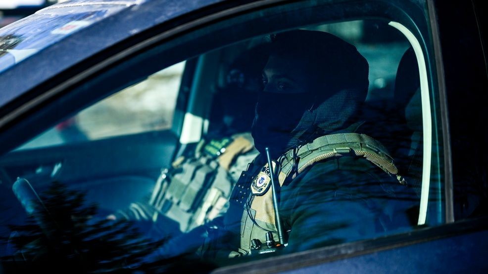 MINNEAPOLIS, MINNESOTA - JANUARY 14: Two ICE agents drive by during a vigil at a memorial near the site where Renee Good was killed a week ago on January 14, 2026 in Minneapolis, Minnesota. Good was fatally shot by an immigration enforcement agent during an incident in south Minneapolis on January 7. (Photo by Stephen Maturen/Getty Images)