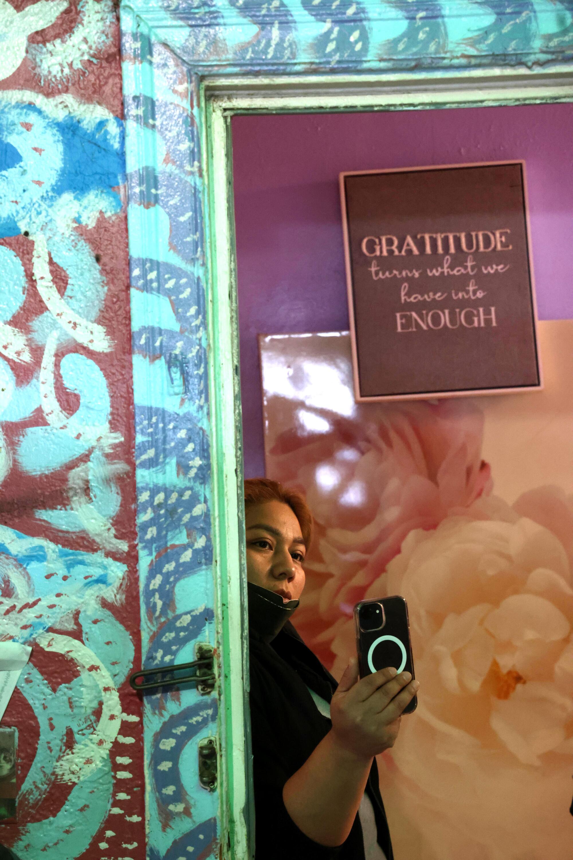 Tenant organizer Arely Soto, with Los Angeles Tenants Union, takes video of a tenant's apartment.