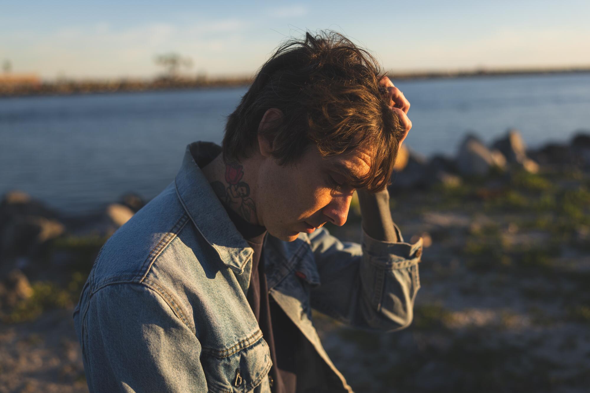 Close-up of rock musician standing on the jetty in Belmont shore
