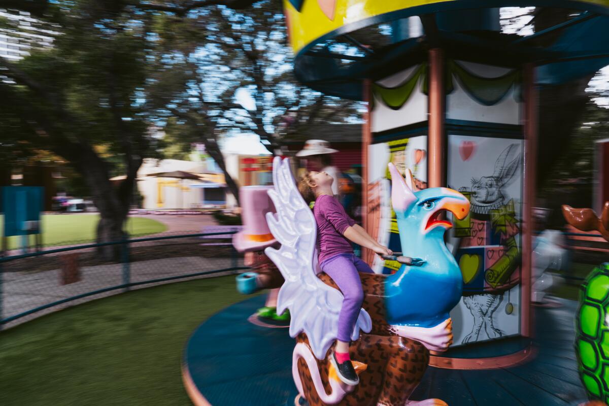 Children ride a carousel at Children's Fairyland in Oakland