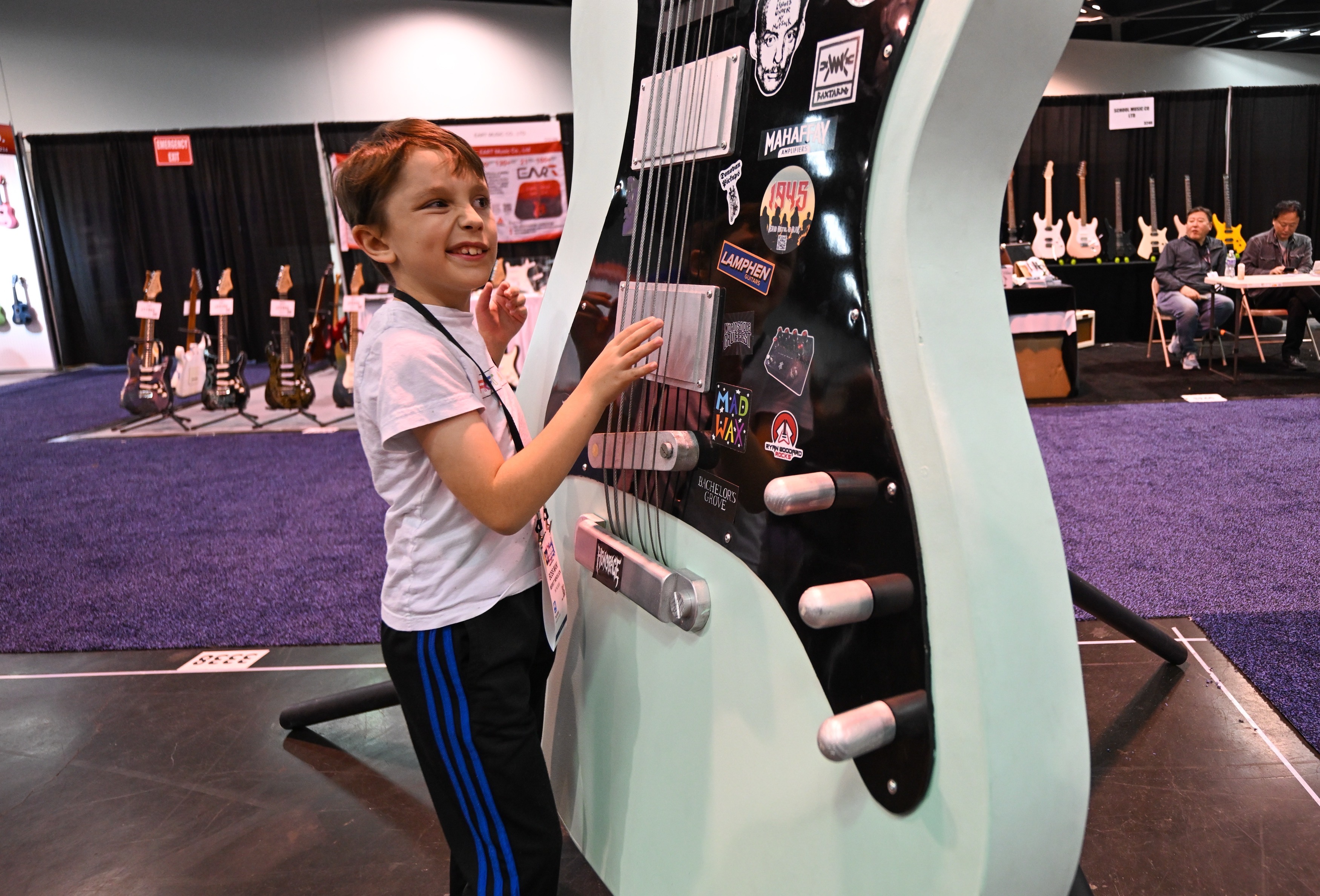 Merritt Mendelson pulls the strings on a giant guitar to...
