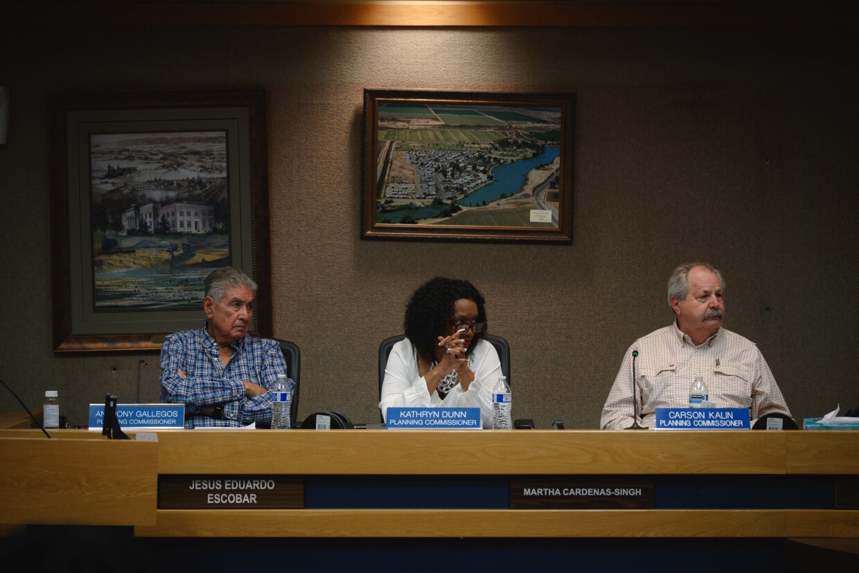 Imperial County Planning Commissioners Anthony Gallegos, Kathryn Dunn and Carson Kalin listen during a hearing on a lot merger for a massive planned data center near the city of Imperial on December 18, 2025 at the county administration building in El Centro, California.
