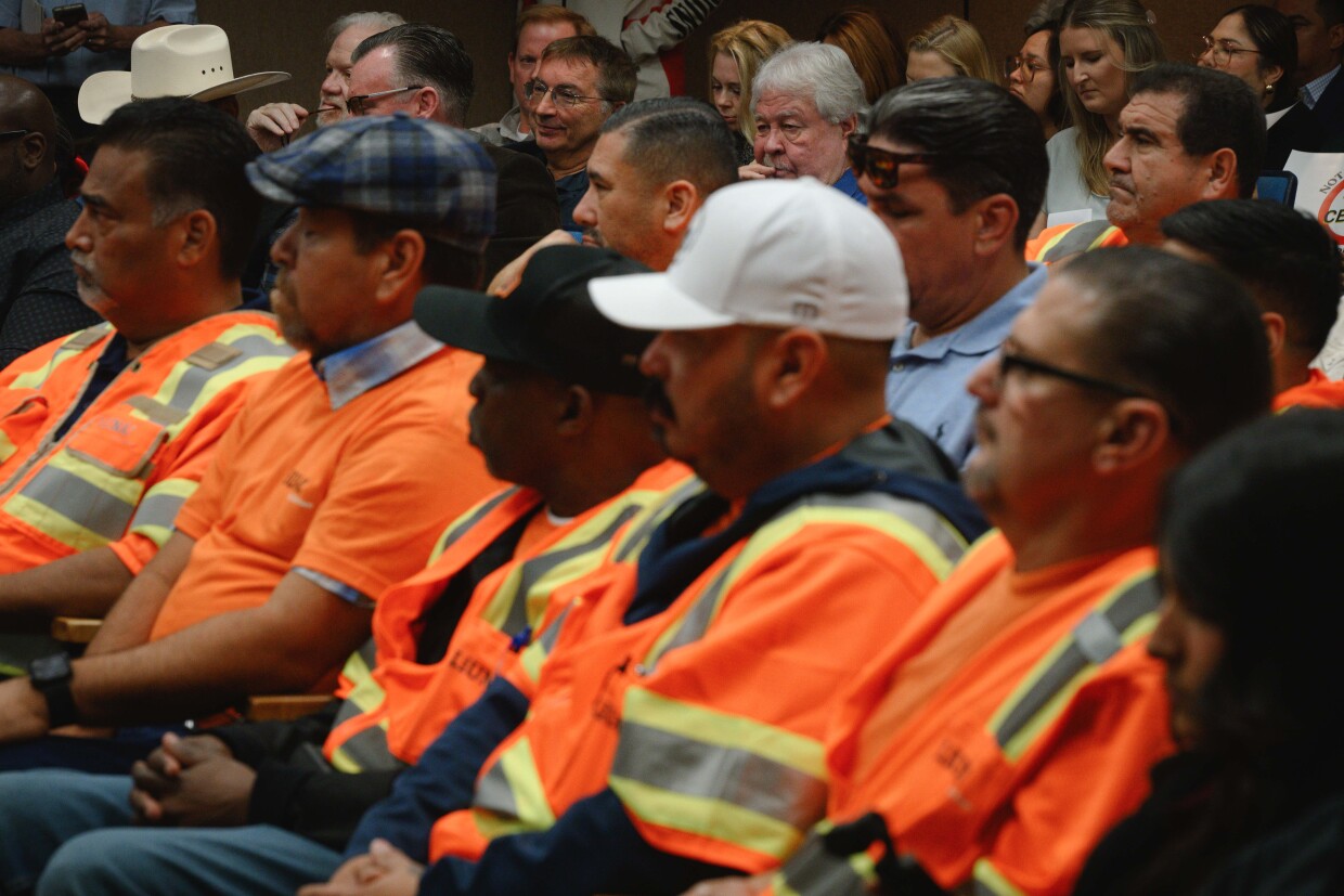 Huntington Beach-based developer Sebastian Rucci and Imperial Valley design consultant Tom DuBose listen, along with a group of labor union members, as the Imperial County Planning Commission holds a hearing on a lot merger for the massive data center Rucci hopes to build near the city of Imperial on December 18, 2025 at the county administration building in El Centro, California.