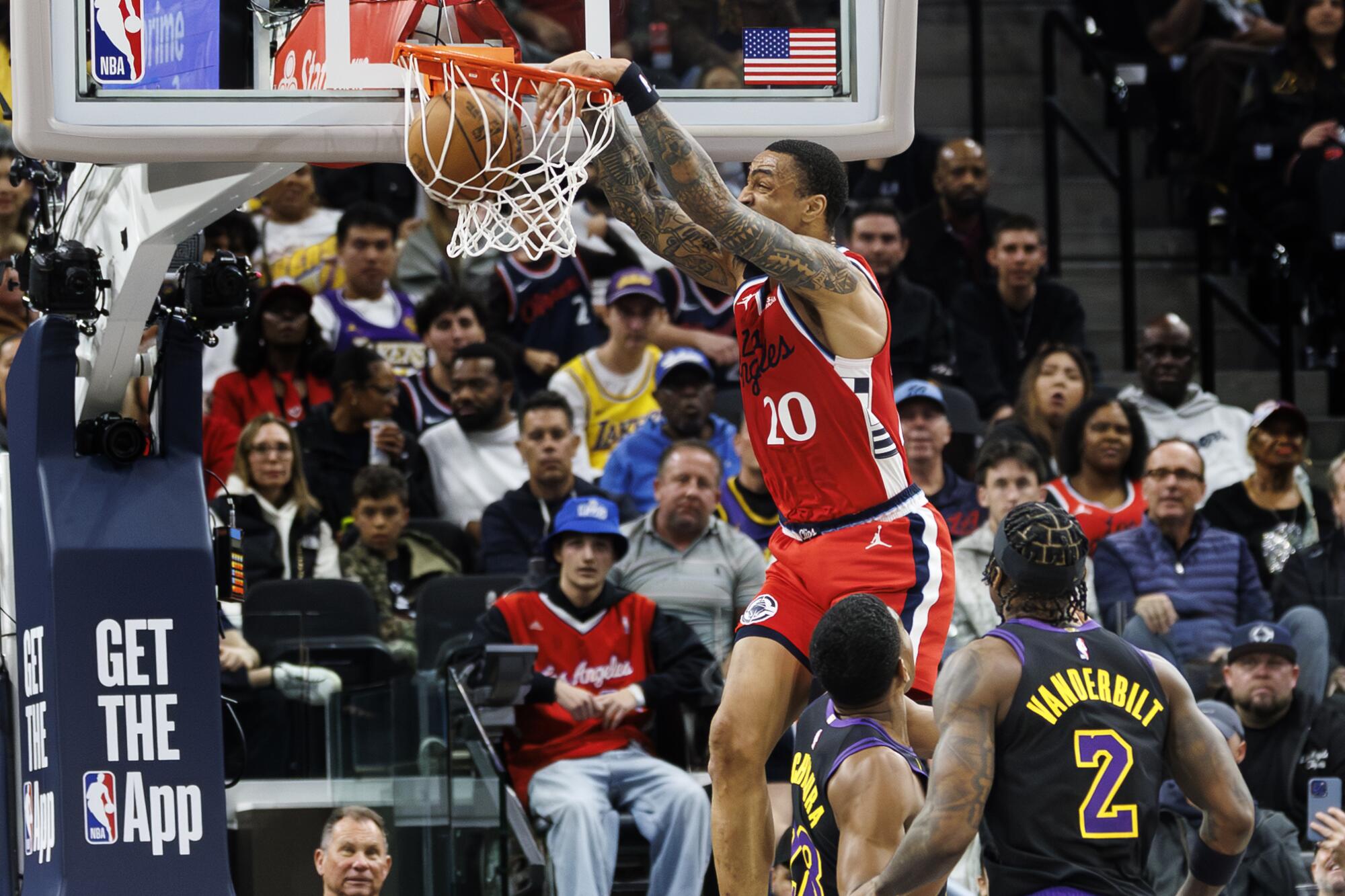 Clippers forward John Collins dunks during the first half Thursday against the Lakers.