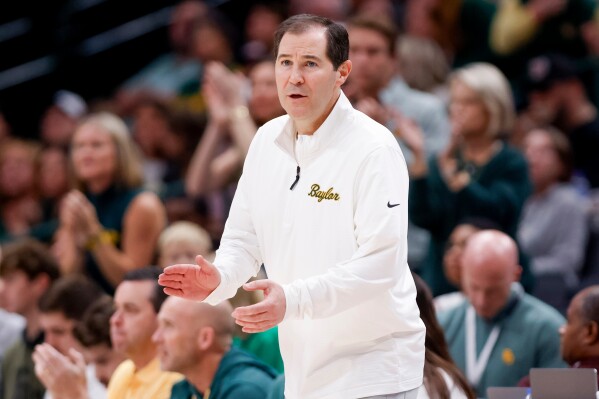 Baylor head coach Scott Drew calls a play to his team during an NCAA college basketball game against Arkansas, Nov. 9, 2024, in Dallas. (AP Photo/Gareth Patterson, file)