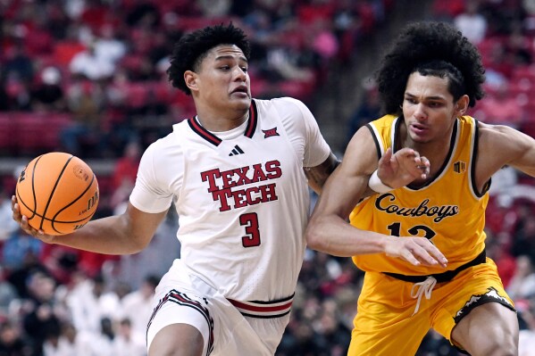 Texas Tech forward LeJuan Watts (3) dribbles the ball while Wyoming guard Adam Harakow (13) guards during the first half of an NCAA college basketball game Sunday, Nov. 30, 2025, in Lubbock, Texas. (AP Photo/Annie Rice)