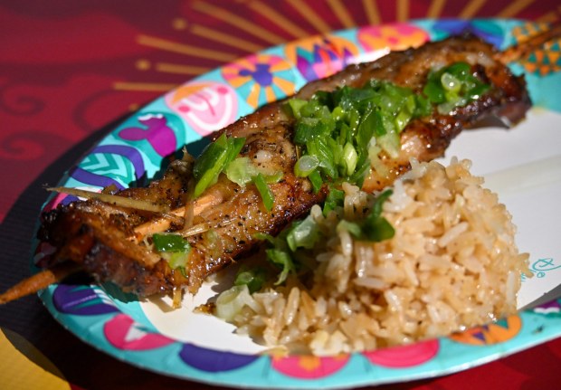 Grilled Lemongrass Pork Belly Skewers served with fried garlic rice, pickled carrots and daikon radish with a side salad available at Paradise Garden Grill in Paradise Gardens Park during Disney California Adventure's Lunar New Year celebration in Anaheim, CA, on Friday, January 23, 2026. They are celebrating The Year of the Horse January 23 through February 22, 2026. (Photo by Jeff Gritchen, Orange County Register/SCNG)