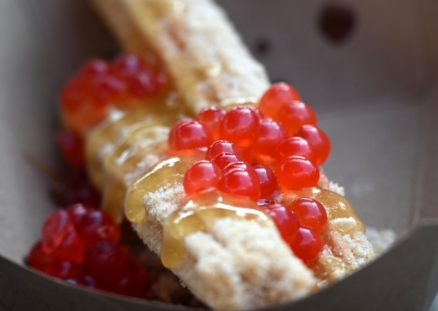 Feng Li Su Churro rolled in shortbread sugar topped with pineapple jelly and cherry-flavored popping pearls available at Hollywood Land Churro Cart during Disney California Adventure's Lunar New Year celebration in Anaheim, CA, on Friday, January 23, 2026. They are celebrating The Year of the Horse January 23 through February 22, 2026. (Photo by Jeff Gritchen, Orange County Register/SCNG)