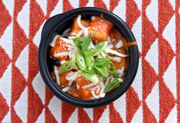 Tteokbokki rice cakes with gochujang sauce topped with cheese, sesame seeds and green onions available at Hollywood Lounge and Studio Catering Co. in Hollywood Land during Disney California Adventure's Lunar New Year celebration in Anaheim, CA, on Friday, January 23, 2026. They are celebrating The Year of the Horse January 23 through February 22, 2026. (Photo by Jeff Gritchen, Orange County Register/SCNG)