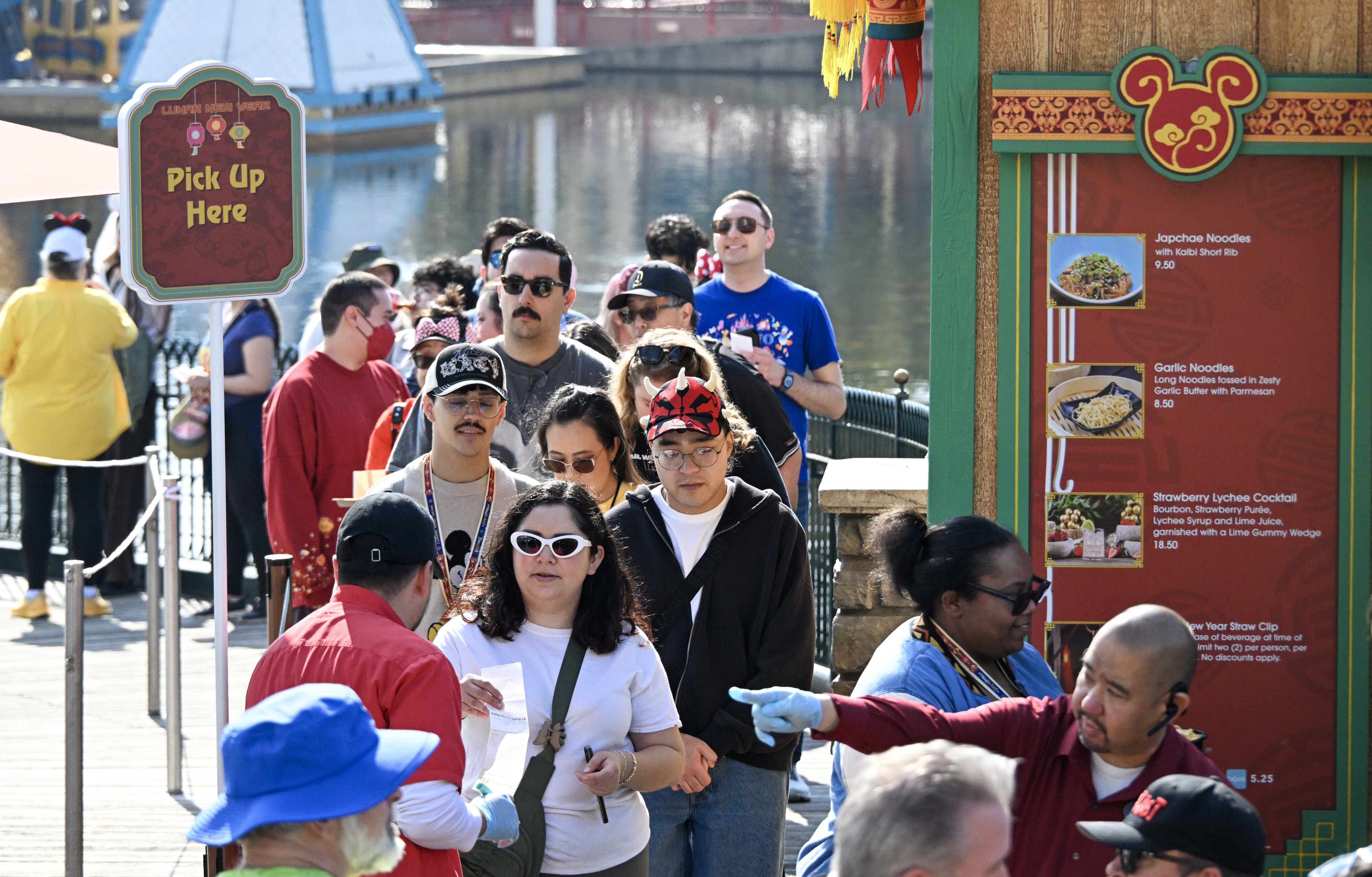 Visitors to Disney California Adventure wait in line at Longevity...