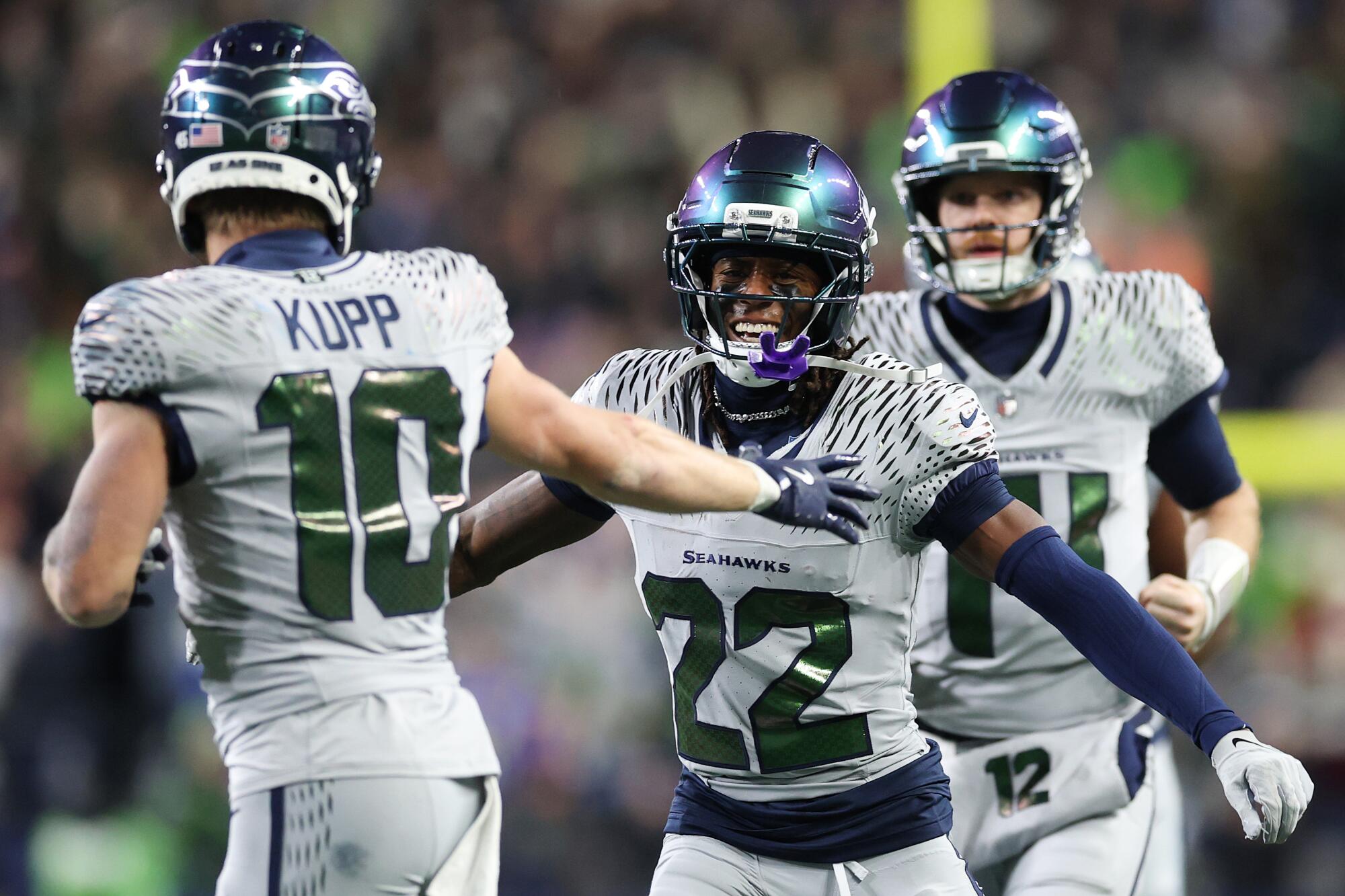 Seattle's Rashid Shaheed (22) celebrates with teammate Cooper Kupp after scoring on a 58-yard punt return.