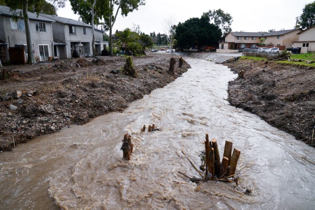 On Tuesday, Feb. 6, 2024, in San Diego, water flows down Chollas Creek near National Avenue. On Jan. 22, 2024, the creek overflowed beyond the banks, flooding homes in the area. (Nelvin C. Cepeda / The San Diego Union-Tribune)