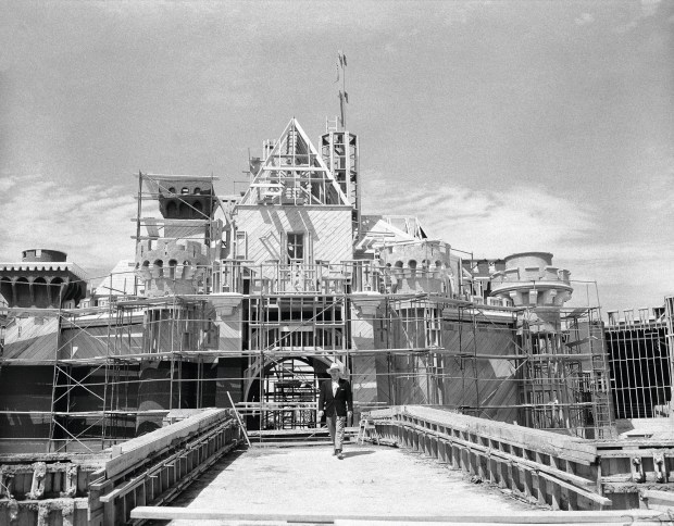 Walt Disney crosses the drawbridge that serves as the entrance to the castle in what will be the heart of Disneyland, in Anaheim, California, on April 16, 1955. (AP Photo/David F. Smith)