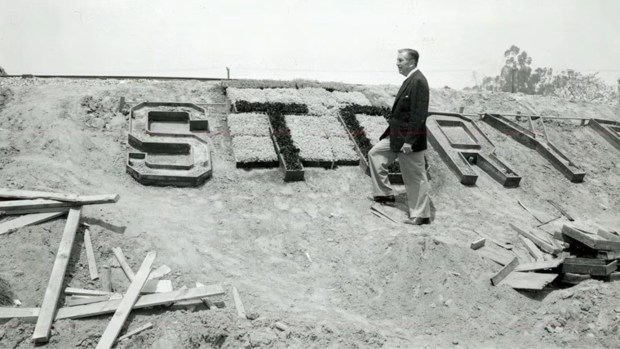 Walt Disney surveys construction of the Storybook Land Canal Boats attraction at Disneyland. (Courtesy of Disneyland)