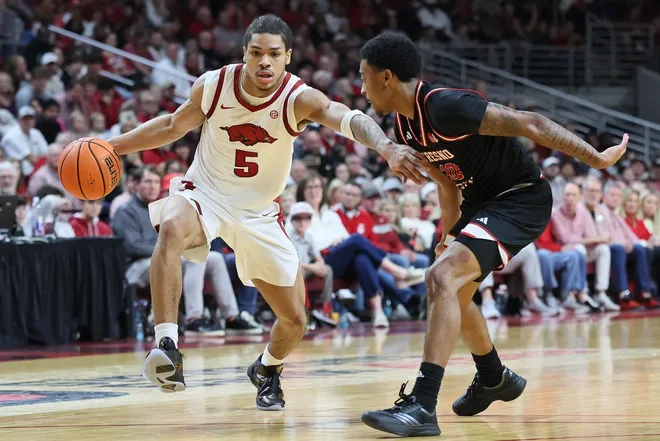 Dec 6, 2025; North Little Rock, Arkansas, USA; Arkansas Razorbacks guard Darius Acuff Jr (5) drives against Fresno State Bulldogs guard Zaon Collins (10) during the second half at Simmons Bank Arena. Arkansas won 82-58.
