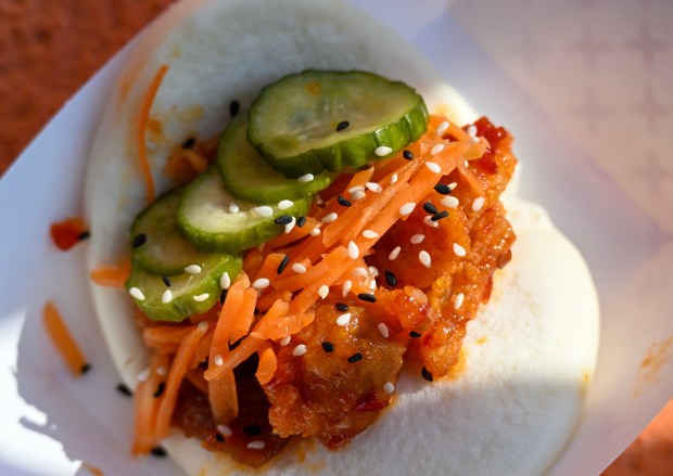 Crispy Fried Chicken Bao coated in sweet chile sauce with cucumbers, carrots and sesame seeds served in a soft bao bun available at Cozy Cone Motel in Cars Land during Disney California Adventure's Lunar New Year celebration in Anaheim, CA, on Friday, January 23, 2026. They are celebrating The Year of the Horse January 23 through February 22, 2026. (Photo by Jeff Gritchen, Orange County Register/SCNG)