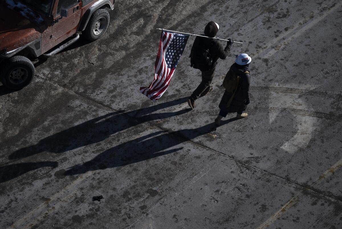 A person carries an American flag