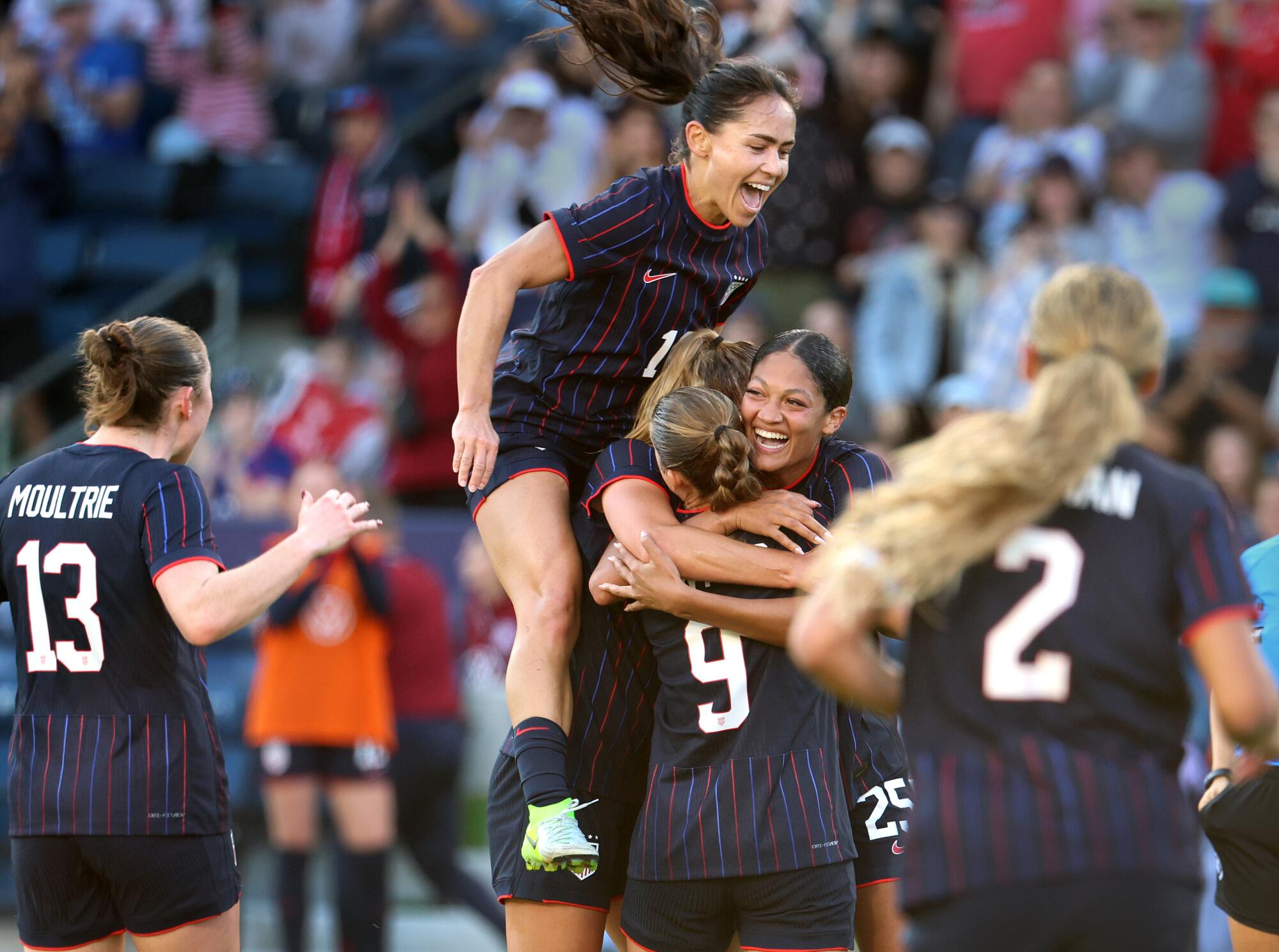 Reilyn Turner, second from right, celebrates with teammates after scoring in an international friendly.