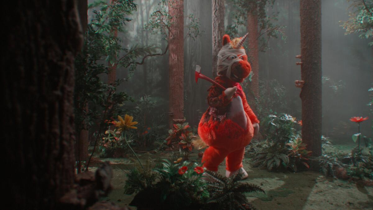 An orange unicorn wanders through a forest with an axe.