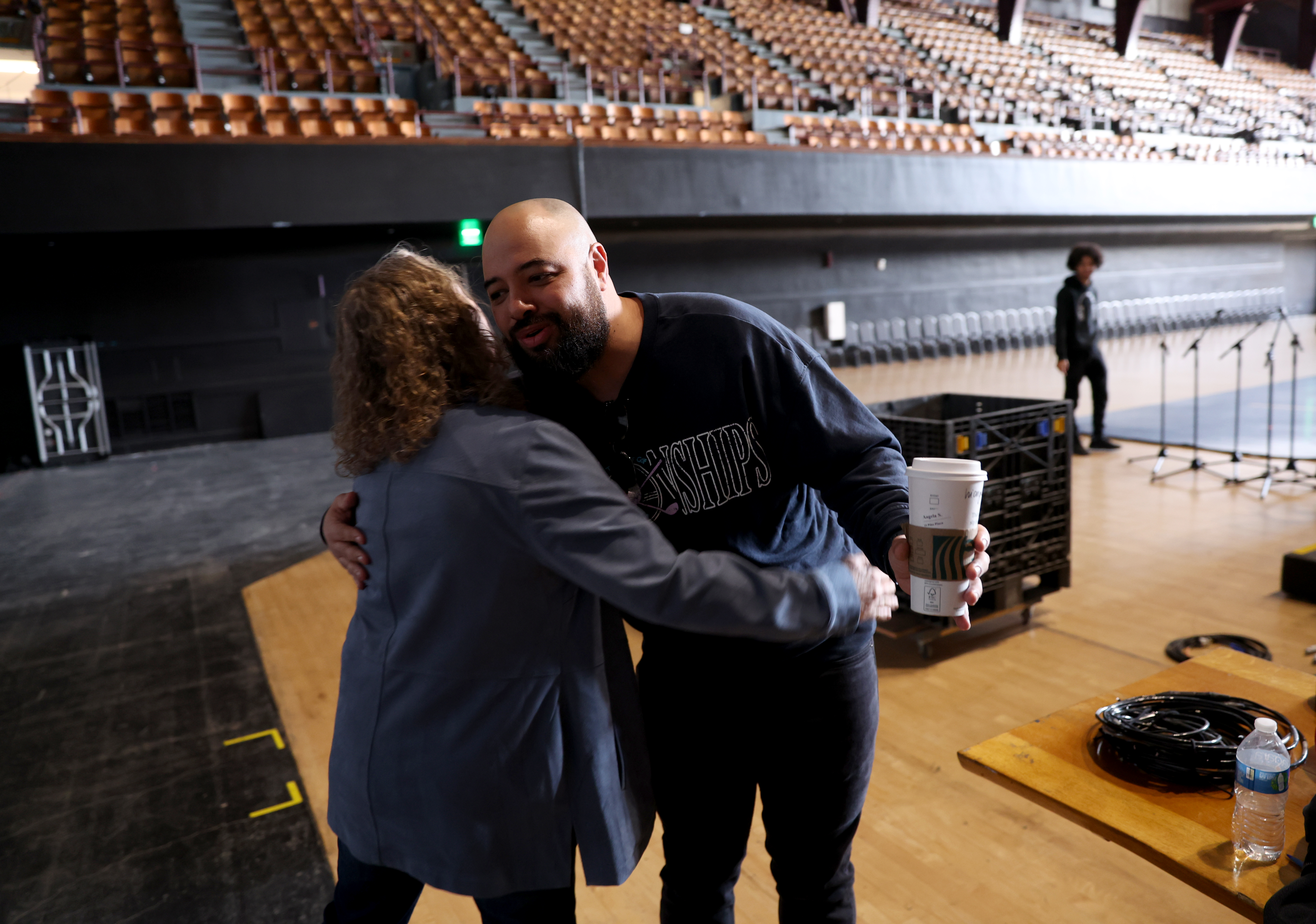 Production Director James Sherwin gives a hug to Nancy Reid...