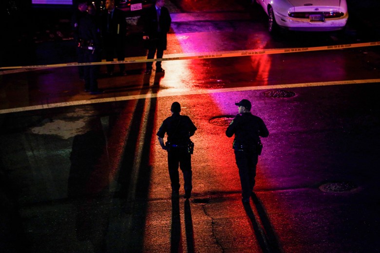 Oakland police officers walk through a crime scene outside the West Oakland BART station on Jan. 3, 2018. Photo by Gabrielle Lurie, San Francisco Chronicle via AP