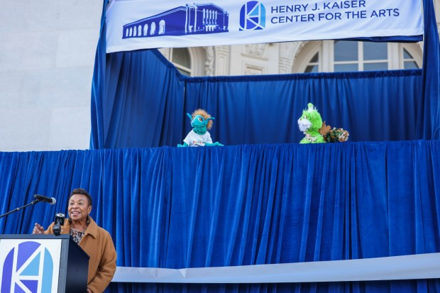 Oakland Mayor Barbara Lee, joined by Children's Fairyland puppets Karl the Elf and Quercus, welcomes guests and community members to the Henry J. Kaiser Center for the Arts during a ribbon-cutting ceremony in Oakland, Calif., on Saturday, Jan. 24, 2026. (Ray Chavez/Bay Area News Group)
