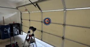 A professional technician from Garage Door Repair Long Beach by On The Spot performing a torsion spring replacement in a North Long Beach neighborhood.