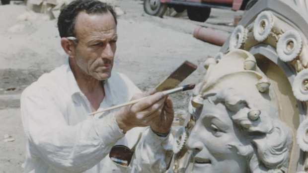A craftsman paints a hand-carved detail at Disneyland before the park opened in 1955. (Courtesy of Disney)