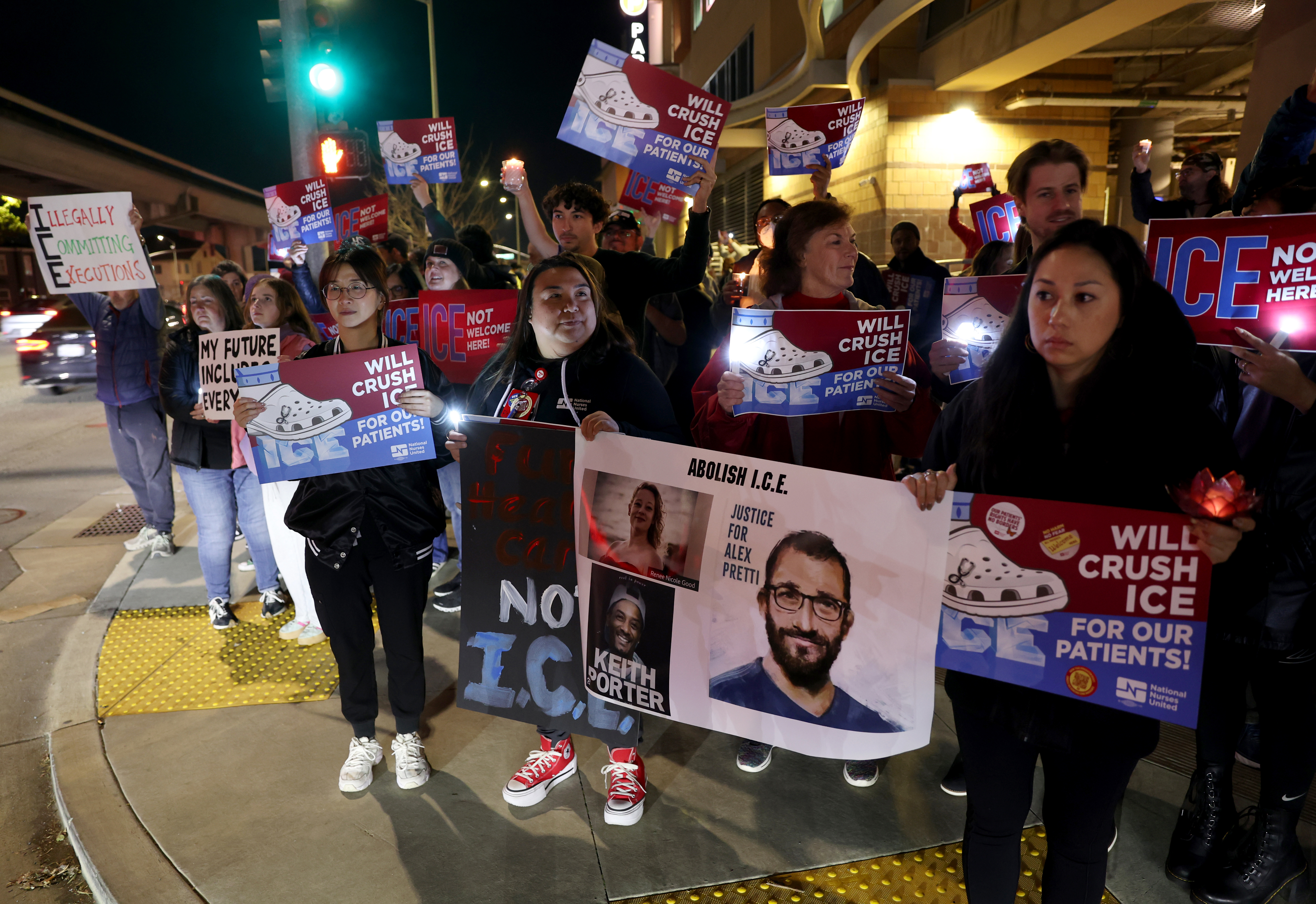 Healthcare professionals and community members attend a protest outside of...