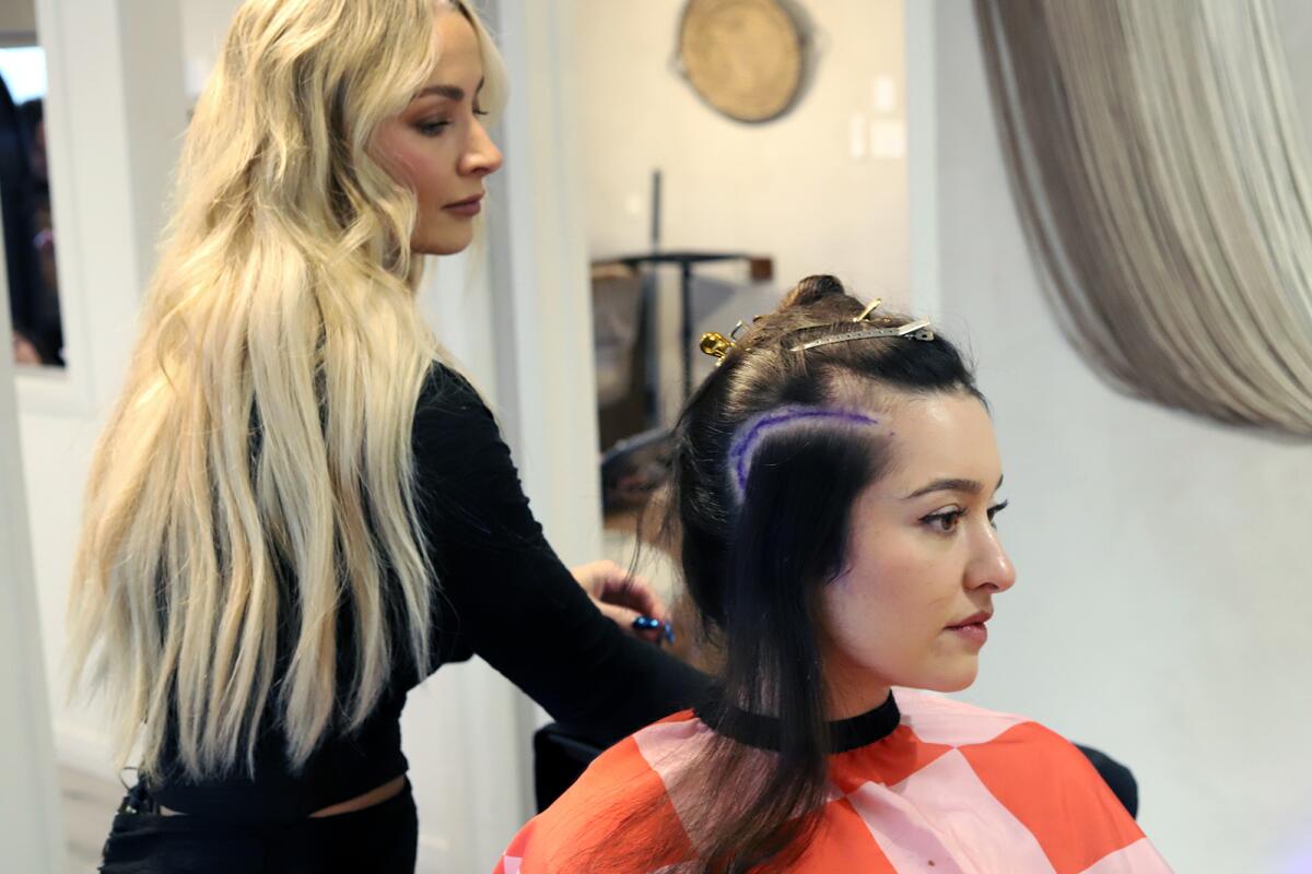Claire Arata, 30, of Aliso Viejo, has her hair "Styled for Surgery" by stylist Loni Kohlmer.