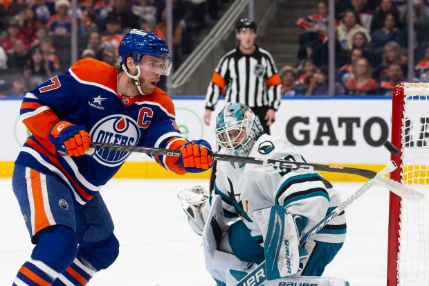 Connor McDavid #97 of the Edmonton Oilers looks to play the puck as goaltender Yaroslav Askarov #30 of the San Jose Sharks defends his net during the second period at Rogers Place on Dec. 21, 2024 in Edmonton, Canada. (Photo by Codie McLachlan/Getty Images)