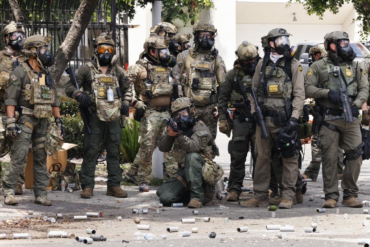 Federal agents holding less-lethal projectile weapons in Los Angeles.