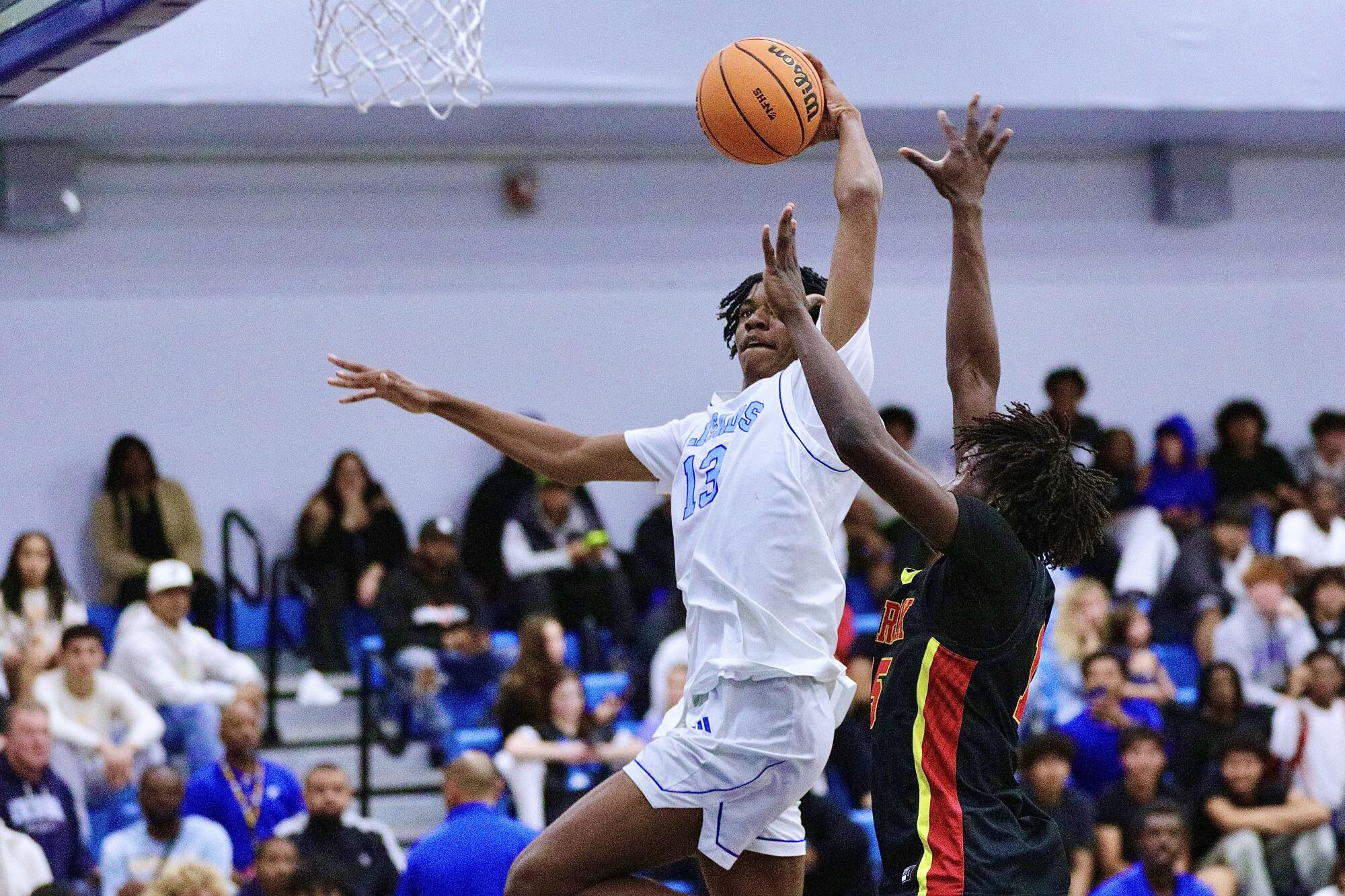 OJ Popoola soars for one of his two dunks in the Dolphins’ first home game since the Palisades fire.