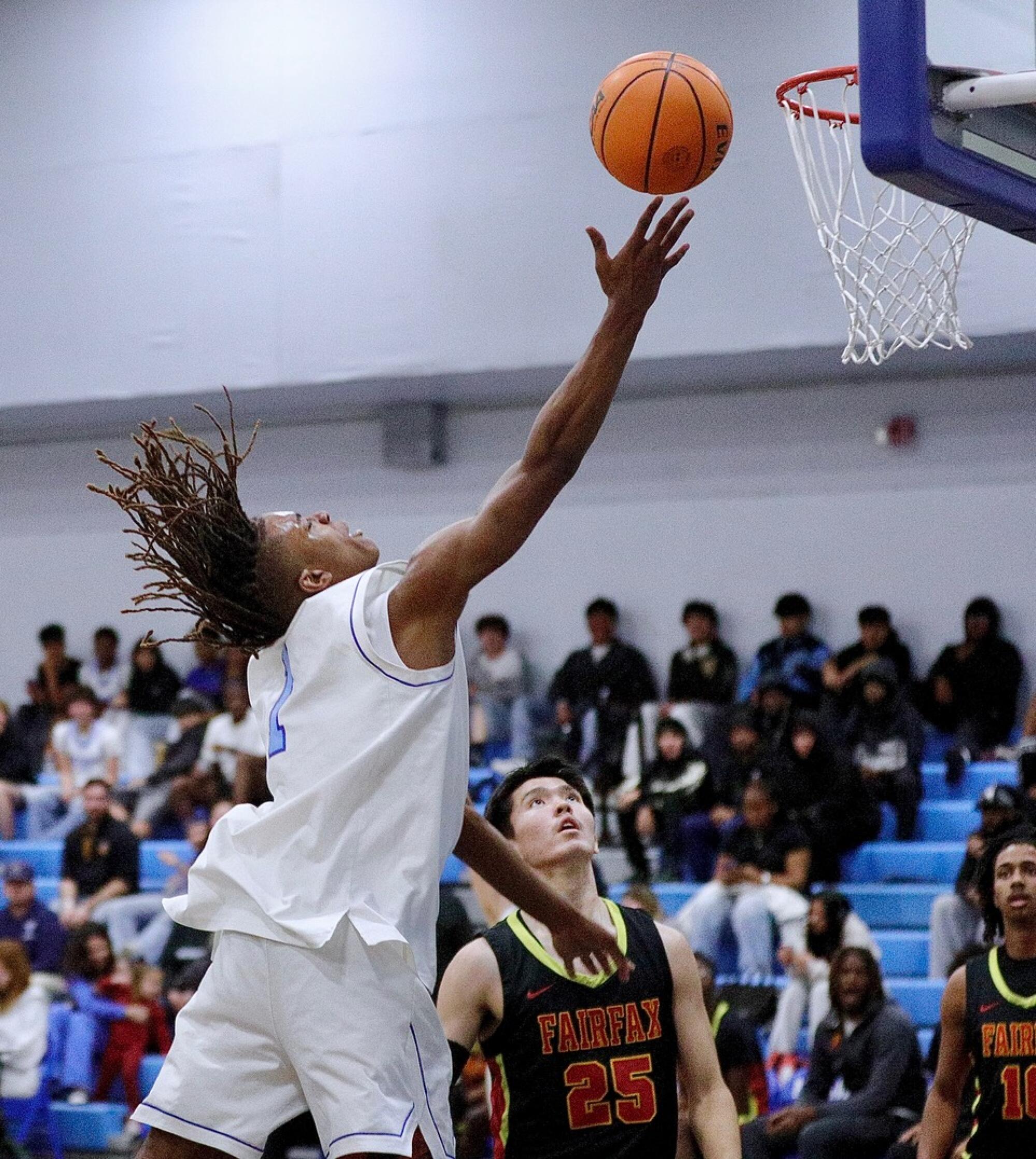 Palisades High's Phil Reed makes a layup against Fairfax in the first half Thursday.