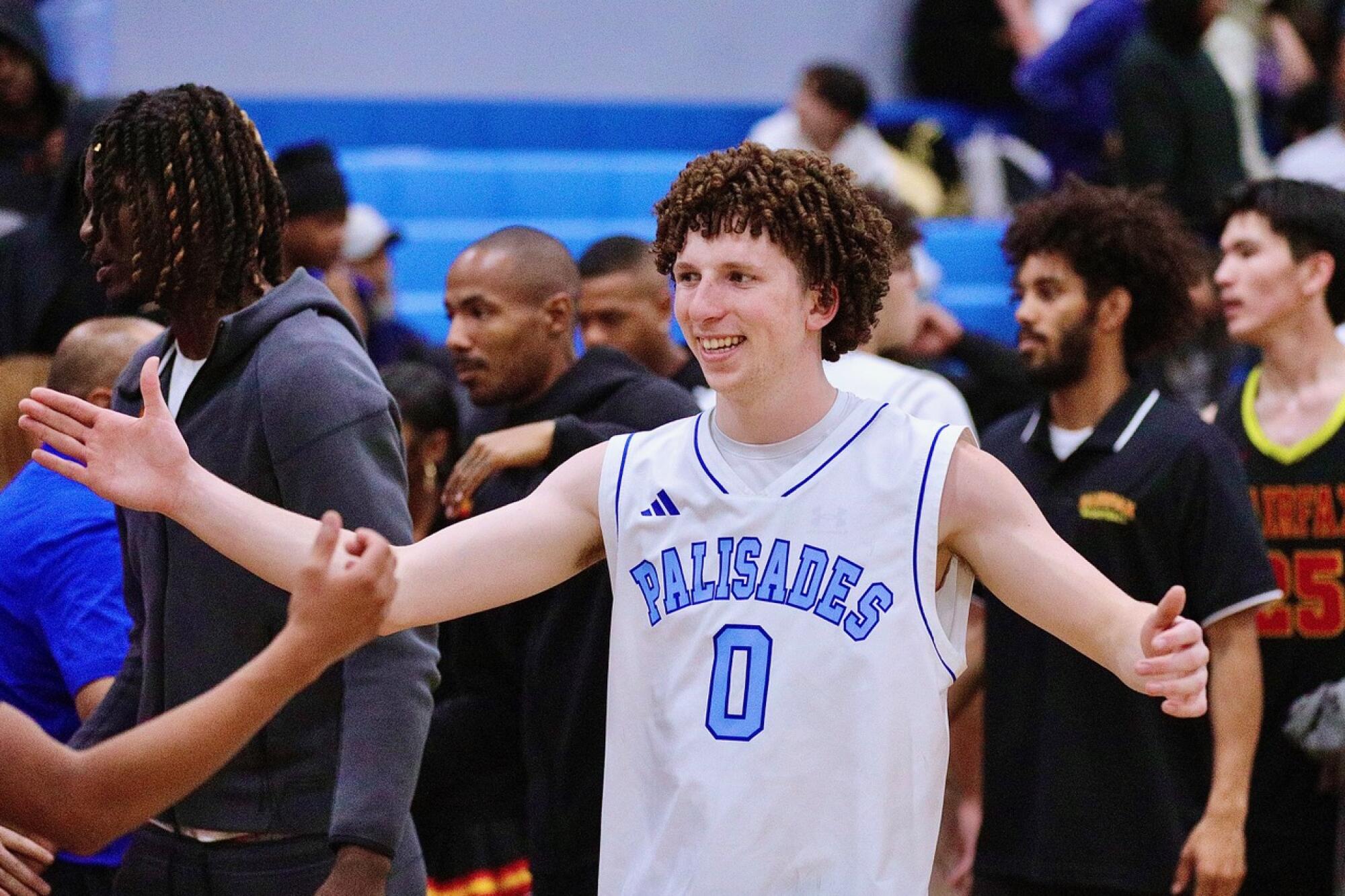 Jack Levey celebrates a big win in the Dolphins’ return to their home court against Western League rival Fairfax.