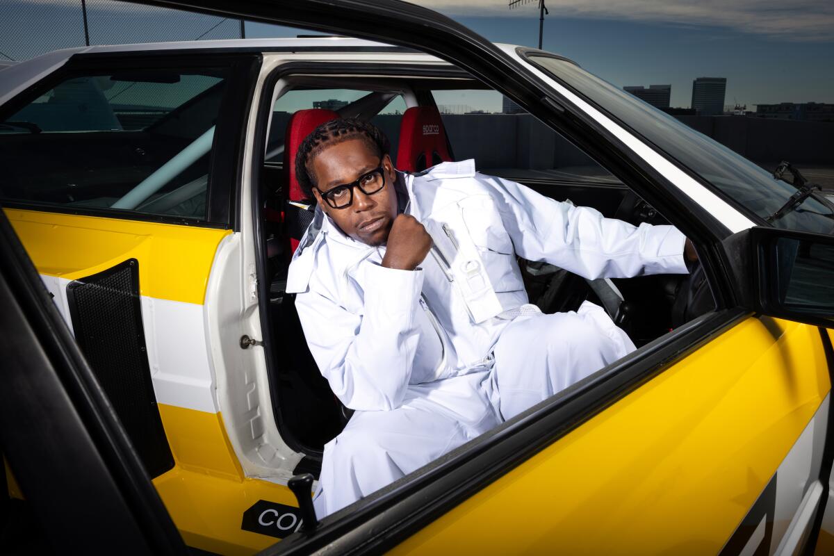 Toliver sits in his car for a photo