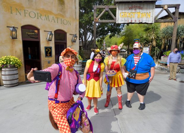 Jason Ybarra, dressed as Crafty Coyote, takes a selfie with Lali Cervantes, Catherine Madinger, center, and Max Jones after entering Knott's Berry Farm in Buena Park, CA, on Thursday, May 6, 2021. The park reopened today after being closed for more than a year due to the COVID-19 outbreak. (Photo by Jeff Gritchen, Orange County Register/SCNG)