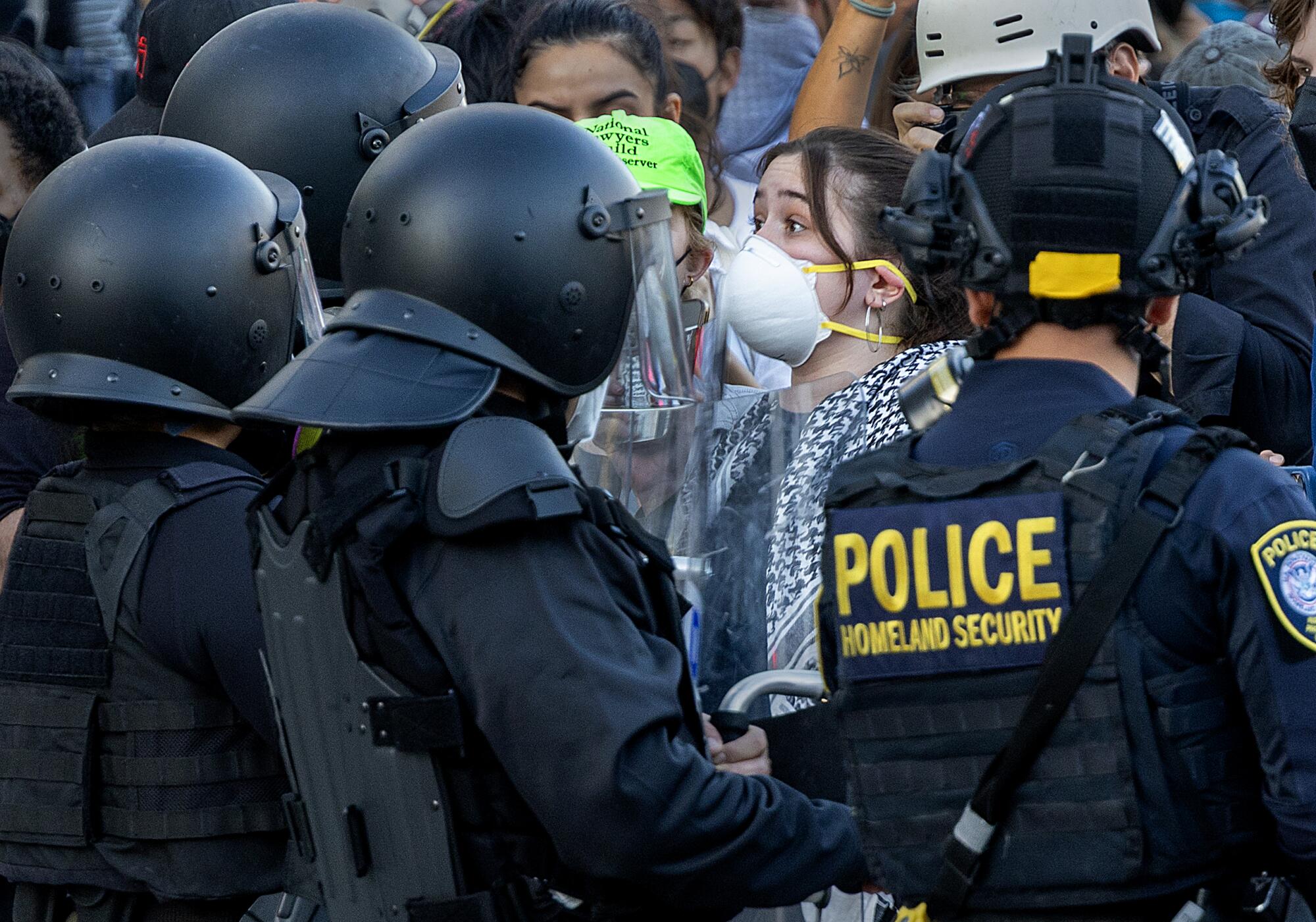 A protester shouts at Department of Homeland Security officers.