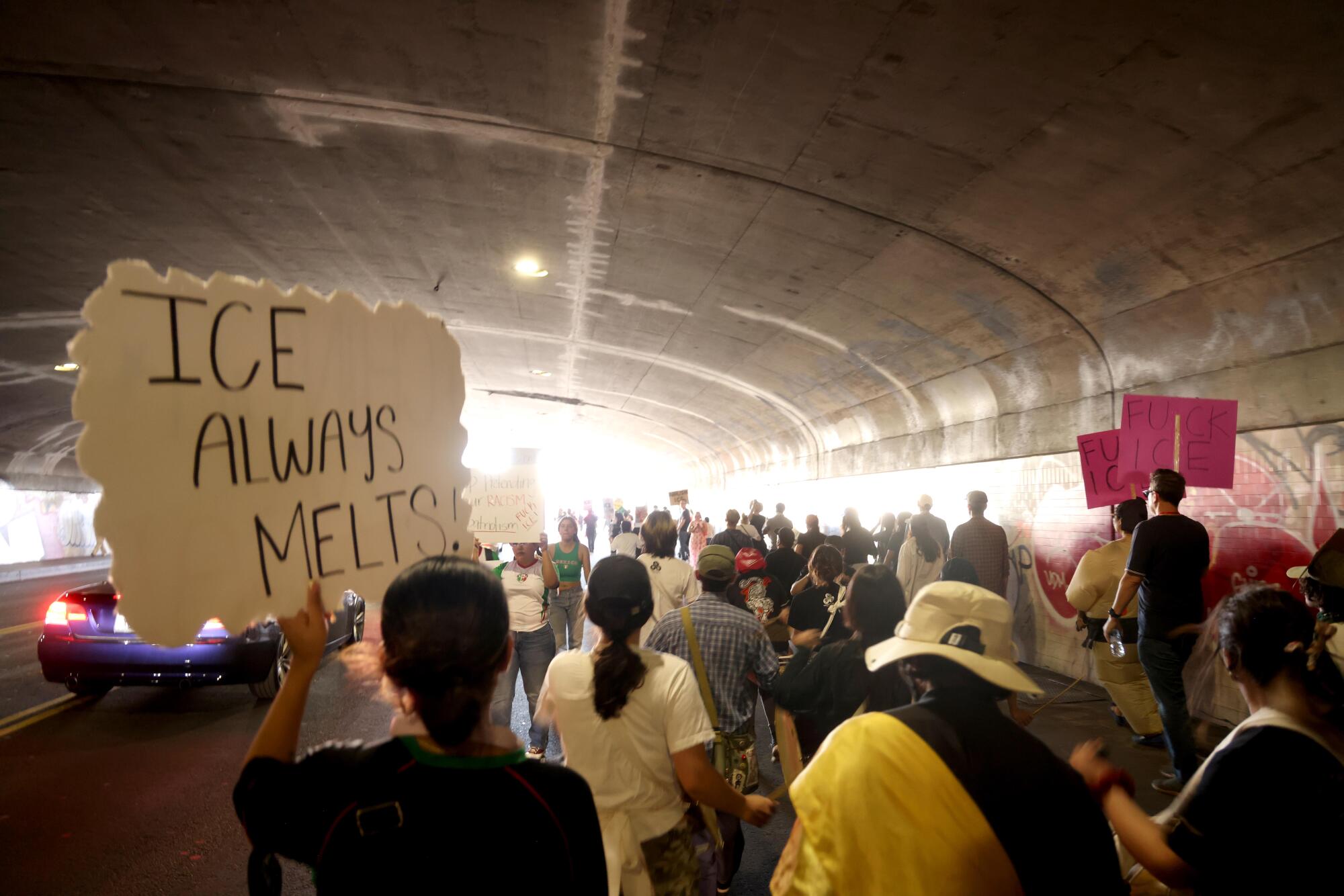 Hundreds of activists and protesters march down Cesar Chavez Avenue in downtown Los Angeles.
