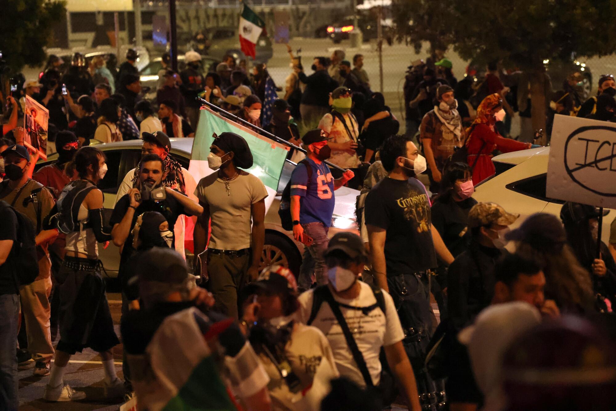 Protesters head south on Alameda as LAPD officers push them out of the area in downtown Los Angeles.
