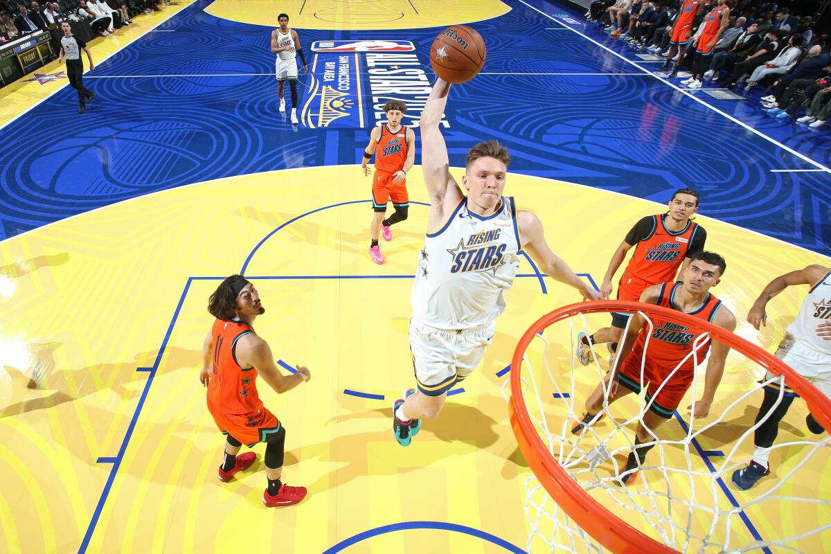 Lakers guard Dalton Knecht of Team C, center, elevates for a dunk during the 2025 Rising Stars Challenge at Chase Center.